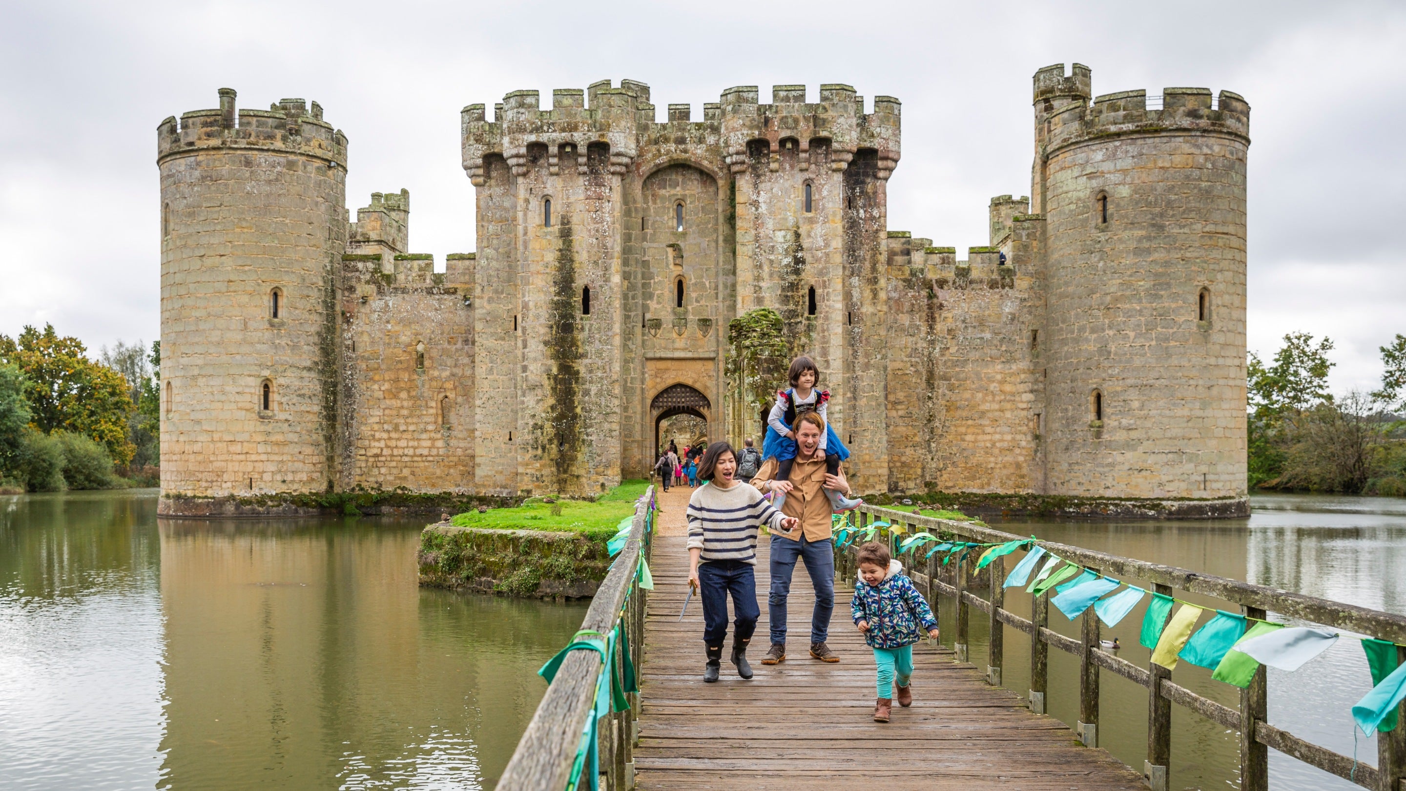 A sunlit castle framed as a vintage postcard